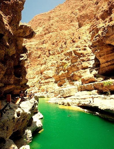 Swimmers enjoying the waters of Wadi Shab Valley, Oman